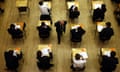 An exam hall full of pupils at desks, seen from almost directly above