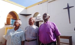 Bishop Brooks, Rev Wycherley Gumbs and Father Hodge in their now roofless Methodist church