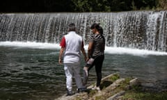 two people in front of a waterfall in Spain