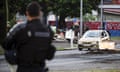 A French gendarme stands guard near people calling for independence as roadblocks have been removed at the entrance of the Riviere Salee disctrict, in Noumea, France’s Pacific territory of New Caledonia