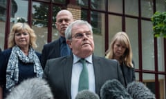 Father of Pte Cheryl James, Des James, speaks to the press with his wife Doreen (with scarf) and other family members, outside the inquest in Woking.