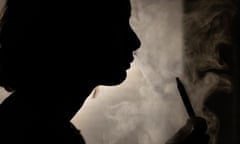 Silhouette of a woman using a vape pen