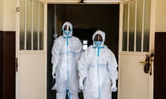Staff in full safety gear outside a new isolation unit at the Connaught hospital in Freetown