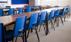 A classroom with empty school desks and chairs