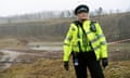 Sarah Lancashire in police uniform standing in the muddy setting of a drained reservoir looking resilient