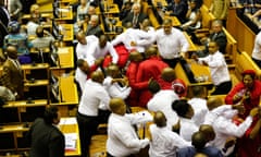 Security officials force out South African opposition party Economic Freedom Fighters (EFF) members during South African President's speech for the 2017's State Of the Nation Address(SONA), on February 9, 2017, in Cape Town.
South African President Jacob Zuma prepared to deliver his annual state of the nation address on February 9, 2017 after deploying more than 440 soldiers to prevent a repeat of violent clashes outside parliament. Zuma, 74, has faced growing criticism since his last address over a series of damaging corruption scandals, worsening unemployment levels and slowing economic growth. / AFP PHOTO / POOL / SUMAYA HISHAMSUMAYA HISHAM/AFP/Getty Images