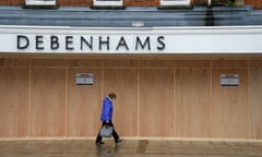 Shoppers Stock Up For Christmas<br>SALISBURY, ENGLAND - DECEMBER 21: Shoppers pass the boarded up Debenhams store on December 21, 2020 in Salisbury, England. A new strain of the Covid-19 virus has led to France closing ports to British goods for 48 hours from Sunday night.  This has led to a number of UK supermarkets warning of potential food shortages just a few days before Christmas. (Photo by Finnbarr Webster/Getty Images)
