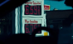 Picture taken through car window shows red digital gas prices of $6.59.