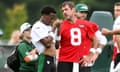 Aaron Rodgers talks with Garrett Wilson during training camp last month