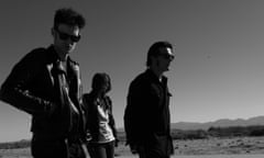black rebel motorcycle club standing in the desert in their jackets and sunglasses