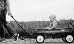 Father pulling son in wagon