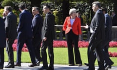 Theresa May looks to passing by heads of government after the family photo at the informal EU summit in Salzburg, Austria