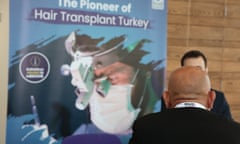 A consultation at the Health Tourism Expo in London on Friday in front of a poster that reads 'The pioneer of hair transplant Turkey'