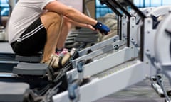 Man working out on rowing machine in health club