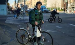 photo of a man with a bike and a paper bag