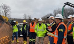 Transportation Secretary Buttigieg with people in high vis vests at train derailment site.