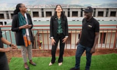 Suella Braverman throws her head back laughing on a tour of a new construction training academy in Kigali, Rwanda