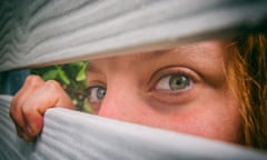 Woman peeks through the neighbours fence