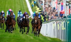 Richard Kingscote and Desert Crown leave the field in their wake.