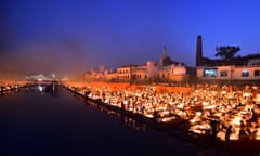 People light earthen lamps on the banks of the Sarayu River on the eve of Diwali in Ayodhya.