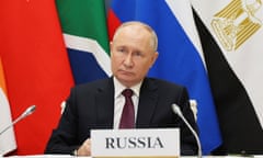 Vladimir Putin with flags behind him