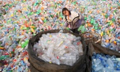 A woman sorts through bottles at a recycling centre in Beijing.