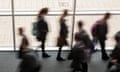 Secondary school pupils moving by a window in a school 