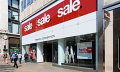 Large sale signs above entrance to French Connection retail fashion business shopping store in Oxford Street London