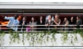 Omar Sy, Hirokazu Kore-eda, Ebru Ceylan, Nadine Labaki, Lily Gladstone, Greta Gerwig, Juan Antonio Bayona, Eva Green and Pierfrancesco Favino taking a photograph on a boat.