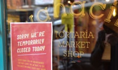 A sign in the window of a Wahaca restaurant closed due to suspected norovirus outbreak.