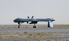 A US Predator unmanned drone armed with a missile stands on the tarmac of Kandahar military airport.