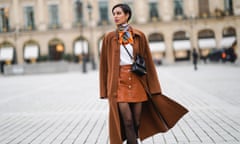 Adriana Seminario wears a brown wool long coat from Rochas, a black leather Jacquemus bag, a brown leather short skirt in Paris this month.