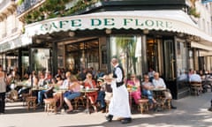 People sit outside a cafe in Paris.