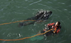 Scuba divers work following a Suez Canal tugboat sinking.