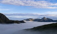 Mountains peek up through heavy fog