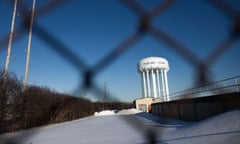 FILES-US-ENVIRONMENT-COURT-FLINT<br>(FILES) In this file photo the water tower at the Flint Water Plant in Flint, Michigan, looms large over the city March 4, 2016 nearly 2 years after the start of the city's water crisis. - The US state of Michigan has agreed to pay some $600 million to victims of the Flint water crisis, a health scandal that became a symbol of social injustice in America, reports said on August 20, 2020. At least 12 people died after the decaying industrial city switched its drinking water source to the polluted Flint River to cut costs in 2014. However, officials failed to add corrosion controls to the new tap water source, allowing lead and other contaminants to leach from the city's aging pipe system, the New York Times and Washington Post reported. (Photo by Geoff Robins / AFP) (Photo by GEOFF ROBINS/AFP via Getty Images)