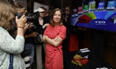 Party leader Li Andersson, wearing a red dress, and with folded arms, greets the media with a  smile after her success at the end of the Left Alliance's European parliament election reception in Helsinki, Finland, on 9 June