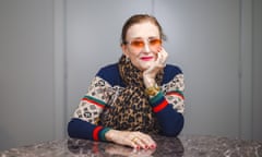 Portrait of Linda Thompson sitting at a round marble table.