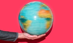 Hand holding a rotating globe.