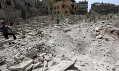 A young people inspect the damage in a cemetery after a reported barrel bomb attack by Syrian government forces in Aleppo, Syria, in April 2015. 