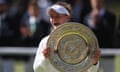 Barbora Krejcikova in her tennis whites and a visor holding the large