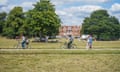 Cyclists riding on a path past walkers in a park