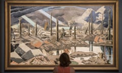 A visitor to Tate Britain’s Paul Nash retrospective in front of his painting The Menin Road, 1918