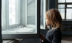 girl standing near window