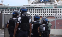 Police on Réunion Island face demonstrators as people protest against the arrival of passengers of the Sun Princess cruise ship without having their temperature checked.