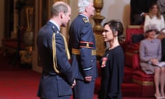 Victoria Beckham holds her award after she was made an OBE by the Duke of Cambridge.