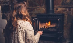 A young woman poking a fire