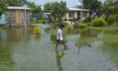 An Indigenous Fijian girl walks over flooded land Matacawalevu, Fiji, after Cyclone Winston in 2016. The UN Committee on the Rights of the Child says the planetary crisis is is ‘an urgent and systemic threat to children’s rights globally’.