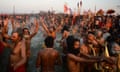 Hindu holy men take a dip at the confluence of the Ganges, Yamuna and mythical Saraswati rivers on Tuesday.
