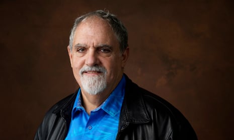 close up of man in blue shirt with goatee